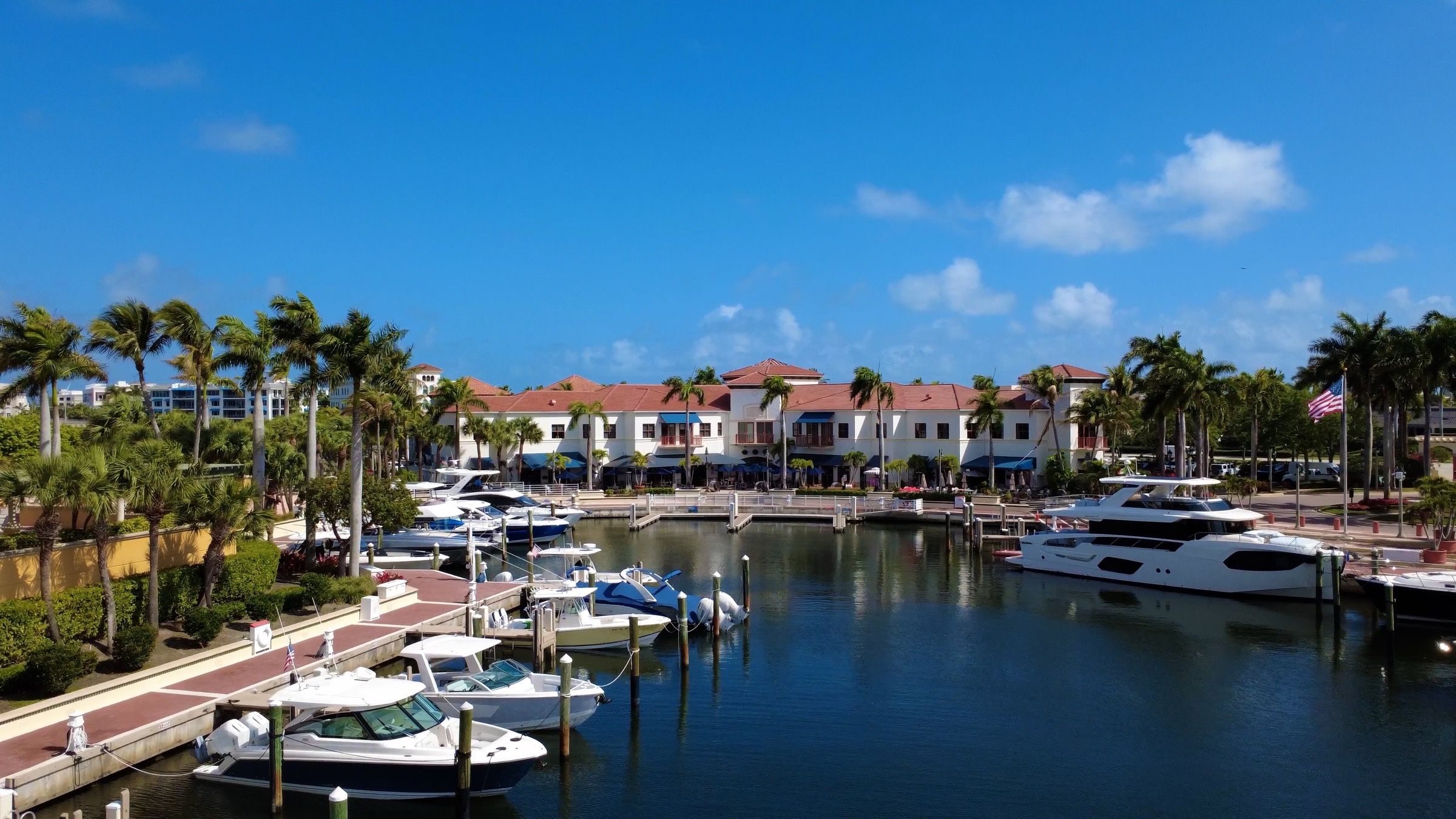 Drone view across the marina to the restaurant, with boats along the Riverwalk docks