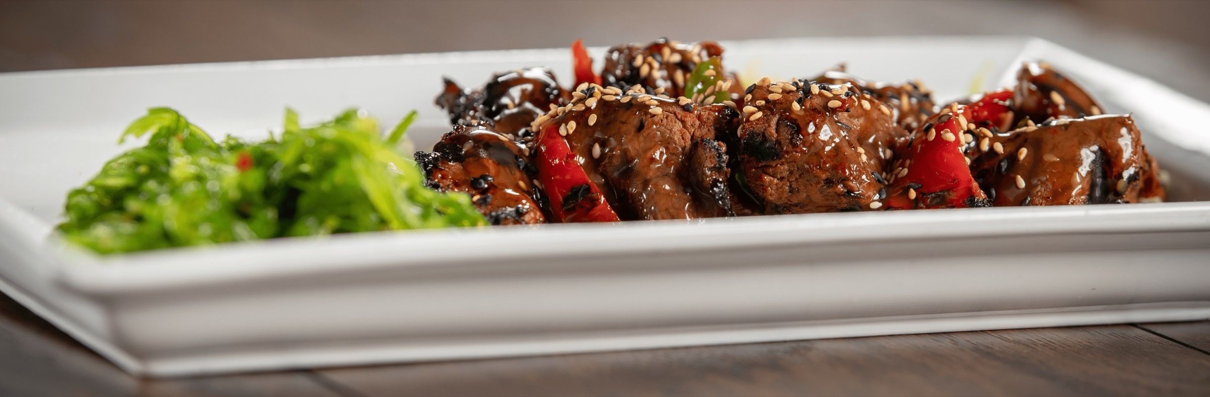 Grilled kimchee beef tenderloin tips with seaweed salad at Dive Bar Restaurant